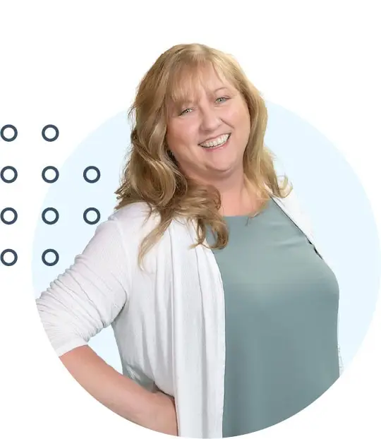 Smiling woman with long blonde hair, wearing a teal top and white cardigan, against a light blue background with abstract circles.