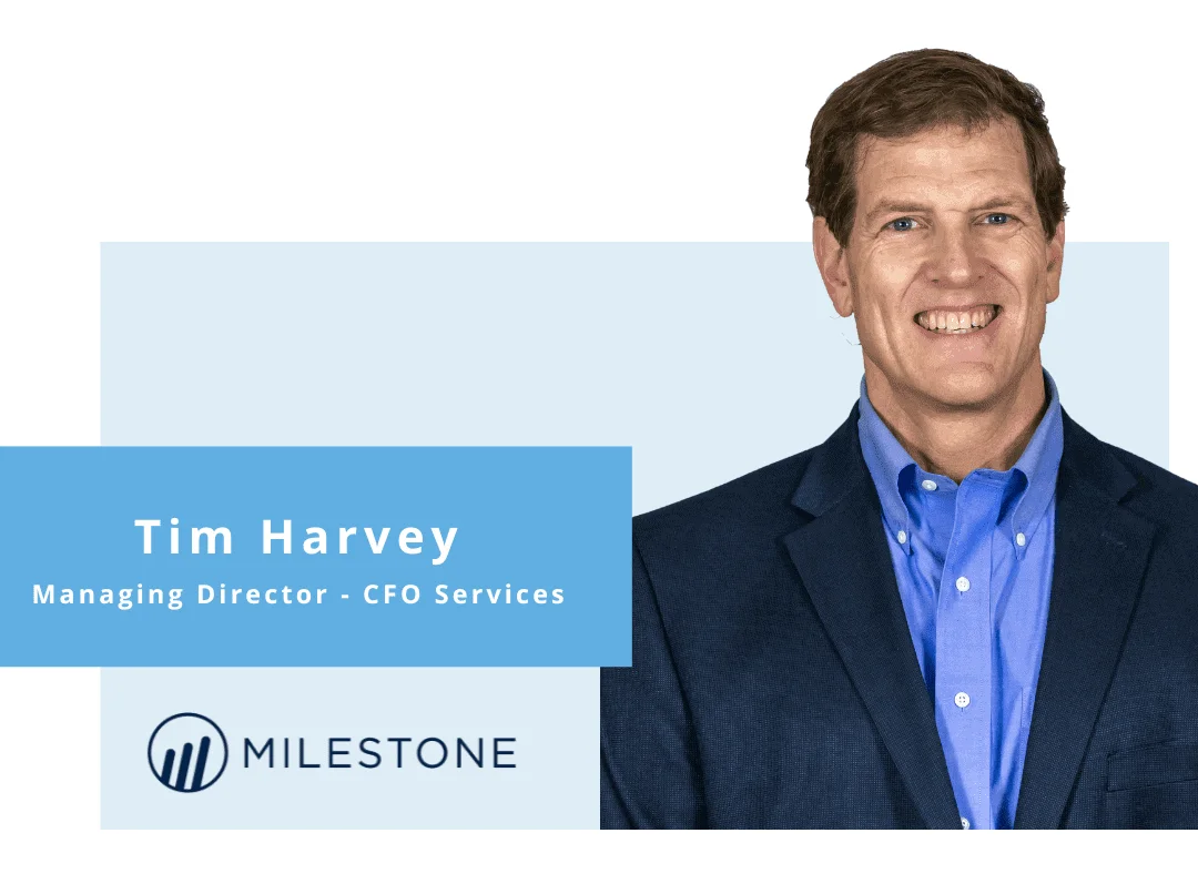 Professional portrait of Tim Harvey, smiling Managing Director in blue blazer, with Milestone CFO Services branding.