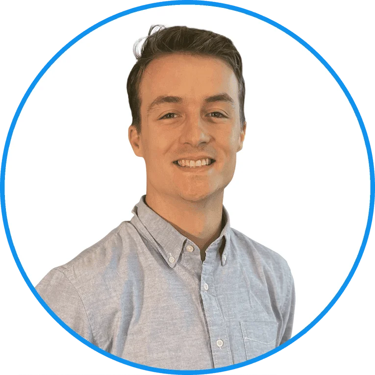 Portrait of a smiling young man in a gray button-down shirt, set against a white background with a blue circular border.