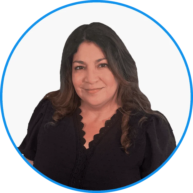 Professional mid-aged Latina woman smiling in a black blouse with lace details, posed against a white background for a corporate profile.