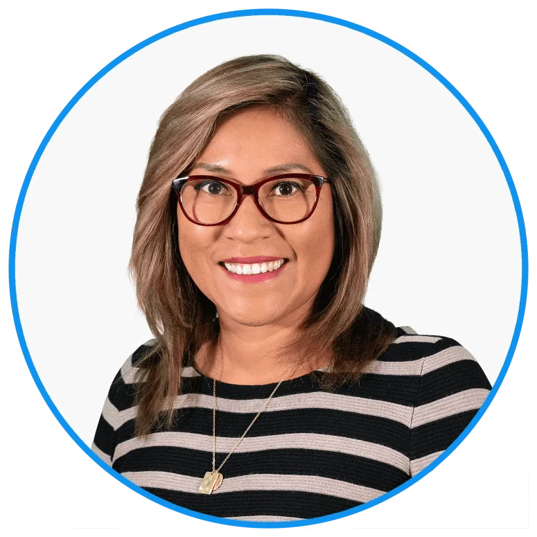 Professional middle-aged Asian woman smiling, wearing glasses, striped top, pendant necklace, isolated on white.