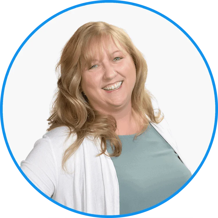 Professional portrait of a cheerful blonde woman in a white cardigan and teal top, ideal for corporate profiles.