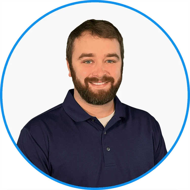 Professional headshot of a smiling bearded man in a navy blue polo shirt, set against a white background with a blue circular border.