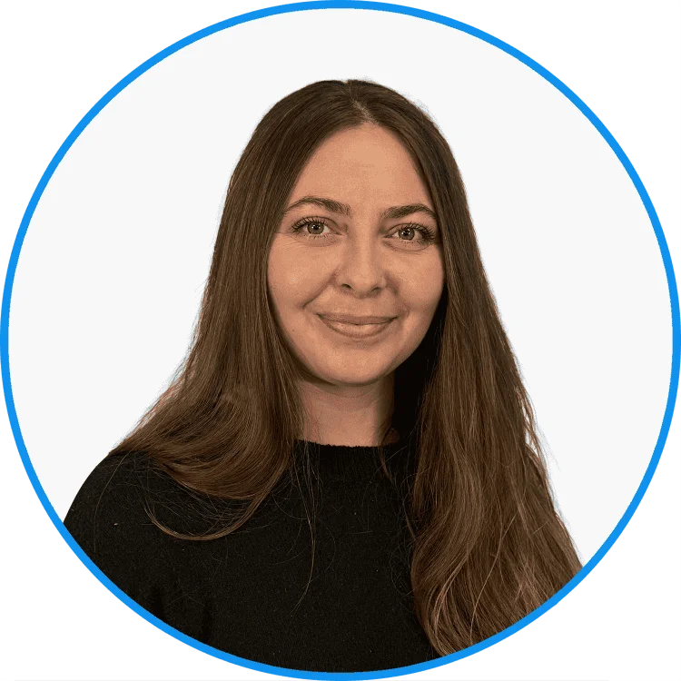 Professional portrait of a smiling woman with long hair, wearing a black top, set against a white background encircled by a blue border.