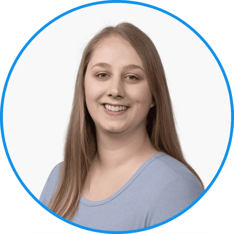 Young woman smiling in a blue shirt with long blonde hair, framed by a circular green and white border, professional headshot for business or personal branding.