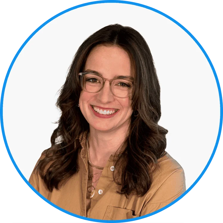 Professional young woman with glasses smiling, wearing a beige blouse, on a white background with a blue circular border.