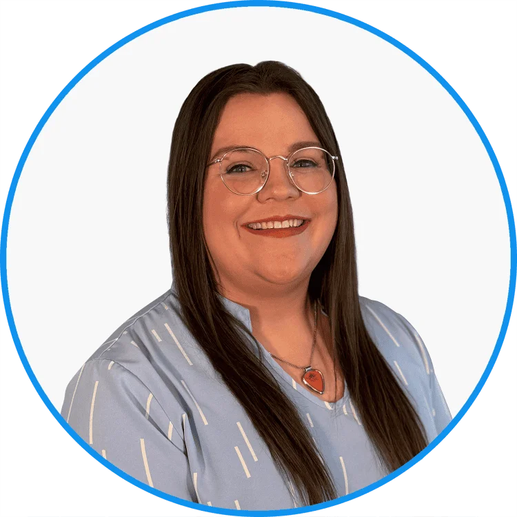 Professional portrait of a smiling woman with long brown hair, wearing round glasses and a blue striped shirt.