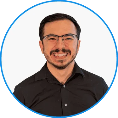 Smiling man with glasses wearing a black shirt set against a plain white background in a circular frame, professional headshot for business profiles.